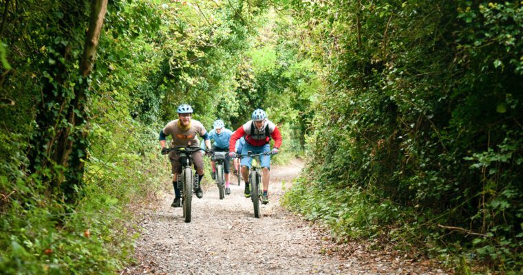Cyclists riding the North Downs Way Riders route